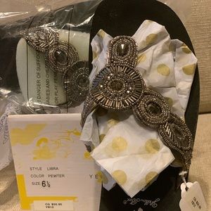 Yellow Box NWT size 6 1/2 pewter flip flops. Never worn. Super cute!!